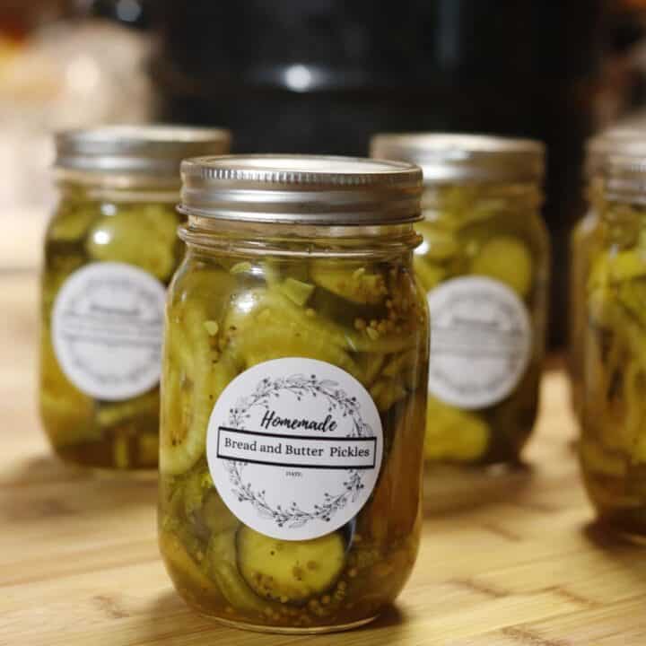 home canned bread and butter pickles with cute labels and a water bath canner in the background
