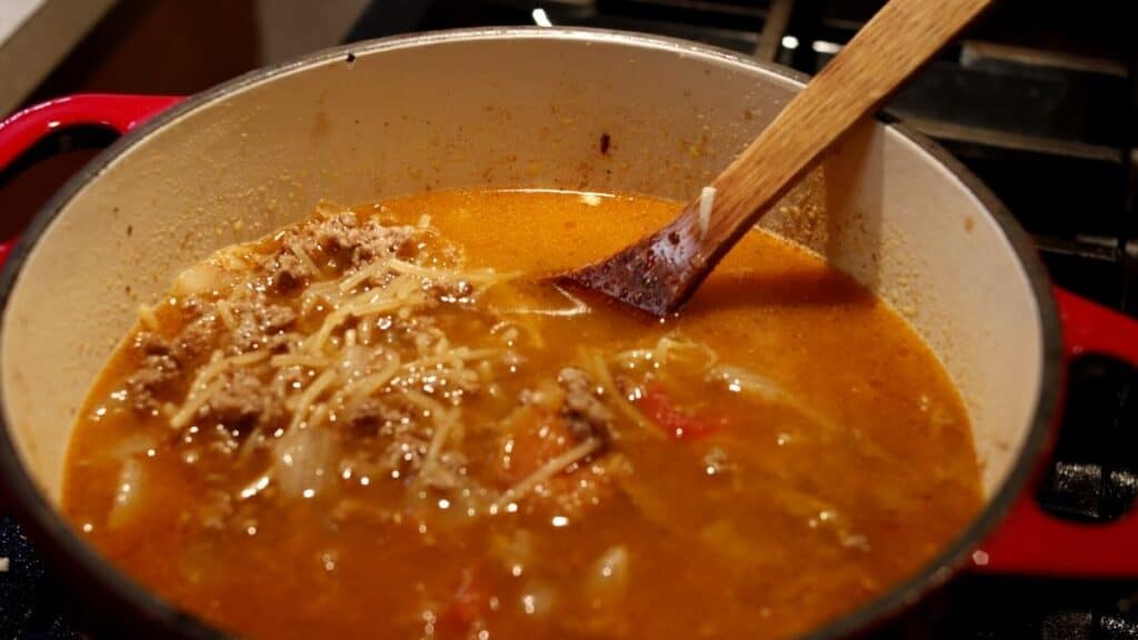 red pot with fideo con carne cooking