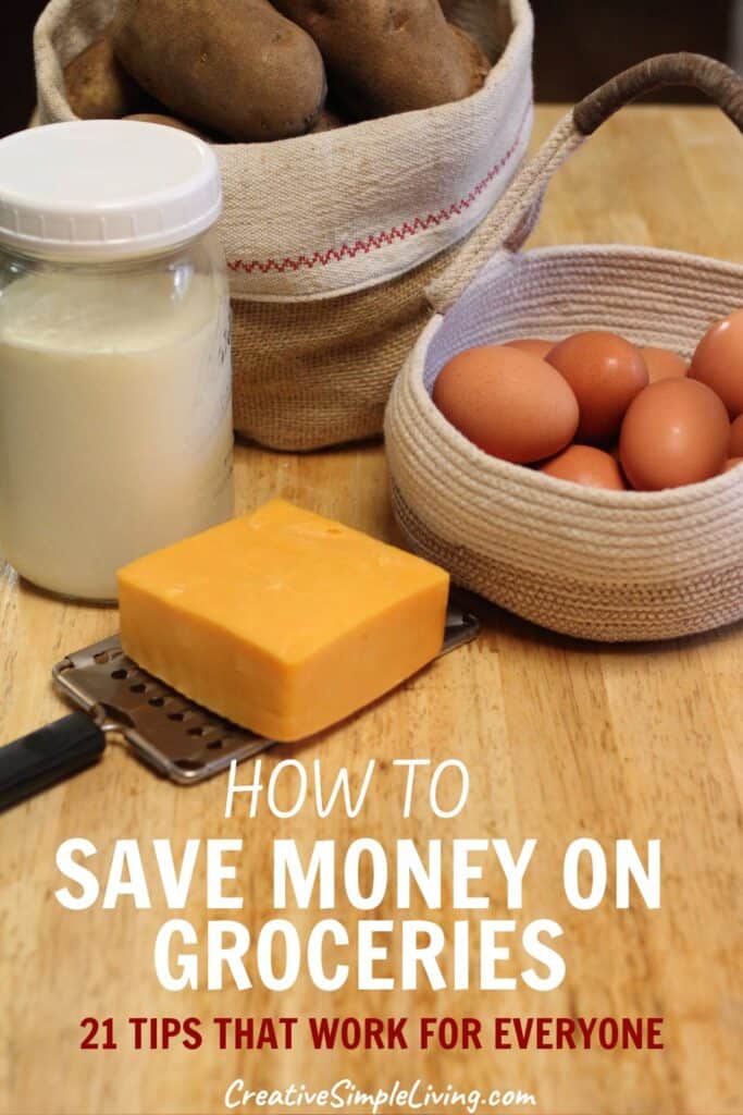 A block of cheese, a jar of milk, brown eggs in a basket, and potatoes in another basket on a wooden table. Text reads: "How to Save Money on Groceries: 21 Tips That Work for Everyone.