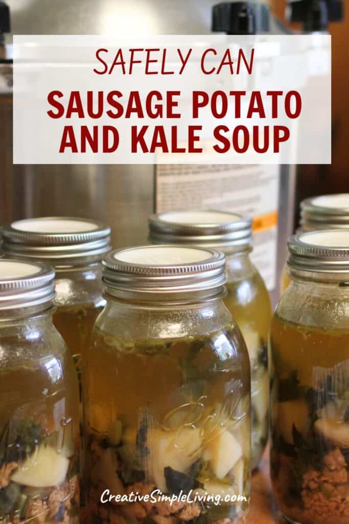 Glass jars filled with hearty sausage potato kale soup sit on a counter, ready for canning. A pressure cooker is visible in the background. Text on the image reads, “SAFELY CAN SAUSAGE POTATO AND KALE SOUP.”.
